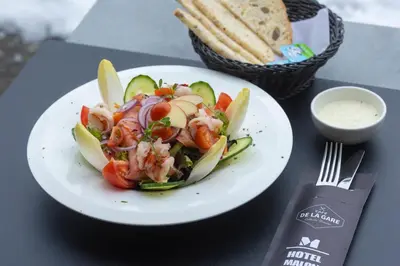 a plate of food with a salad on a table at Hotel Malon in Leuven