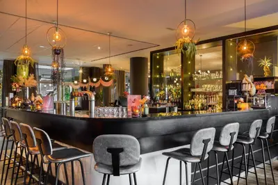 a bar in a restaurant with stools at Van der Valk Hotel Brussels Airport in Diegem