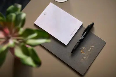 a pen and a piece of paper on a table at Van der Valk Hotel Brussels Airport in Diegem
