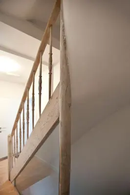 a wooden staircase in a room with a white ceiling at Drabstraat 2 Apartment in Ghent