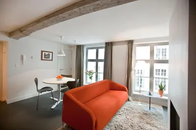 a living room with an orange couch and a table at Drabstraat 2 Apartment in Ghent