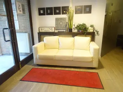 a white couch in a living room with a red rug at Budget Flats Brussels in Brussels