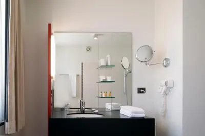 a bathroom with a sink and a mirror at Hotel Verlooy in Geel