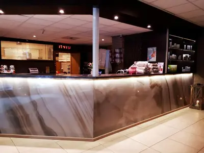 a bar in a store with a stainless steel counter at Hotel Thermen Dilbeek in Dilbeek
