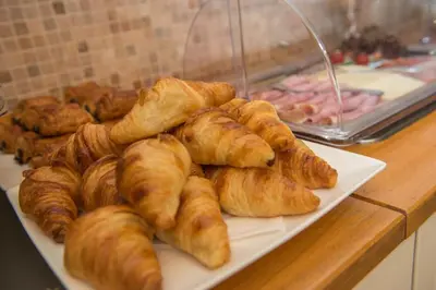 a plate of croissants and other pastries on a counter at Hotel Thermen Dilbeek in Dilbeek