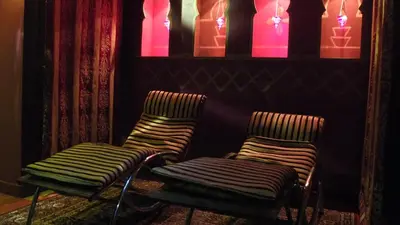 two chairs in a room with pink and purple lights at Hotel Thermen Dilbeek in Dilbeek