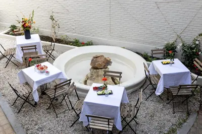 a group of tables and chairs with flowers on them at Hotel Rubenshof in Antwerp