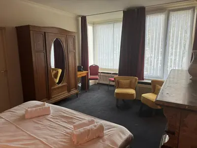 a hotel room with a bed and a mirror at Hotel Rubenshof in Antwerp