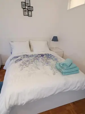 a bedroom with a white bed with towels on it at Florya Studio Woluwe in Brussels