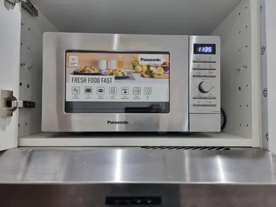 a microwave oven with a picture of food in it at Florya Studio Woluwe in Brussels