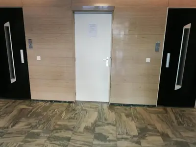a pair of doors in a room with wooden walls at Florya Studio Woluwe in Brussels