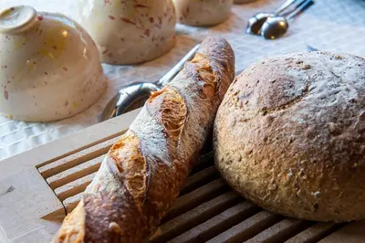 two loaves of bread sitting on a cutting board at Hof ter Dreef in Meise