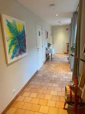 a hallway with a painting on the wall at Hof ter Dreef in Meise