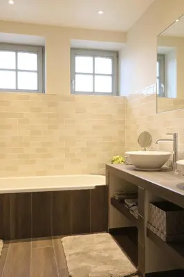 a bathroom with a sink and a tub and a mirror at Hof ter Dreef in Meise
