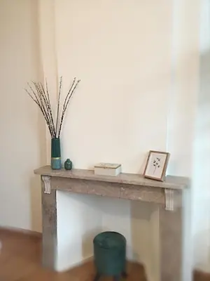 a table with a clock and a vase on it at Hoogpoort Residence George in Ghent