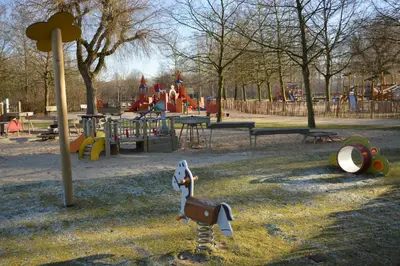 a park with a playground with slides and swings at Ars Vivendi in Moerbeke