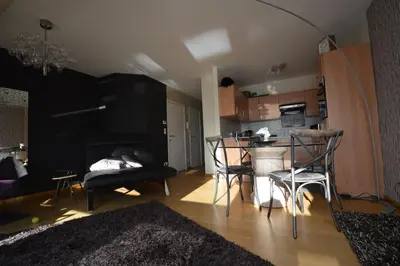 a living room with a kitchen with a table and chairs at Ars Vivendi in Moerbeke