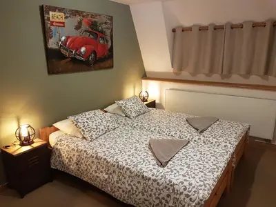 a bedroom with a bed and a red car on the wall at Brigitte & Alain in Brussels