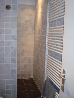 a bathroom with a shower with a shower curtain at Brigitte & Alain in Brussels