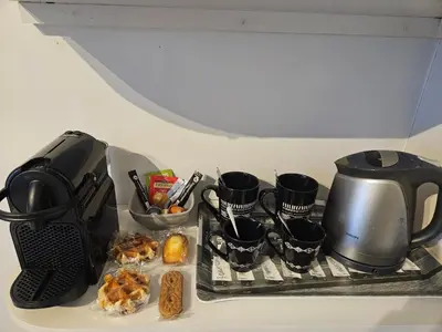 a stove top with a tea kettle and some food at Brigitte & Alain in Brussels