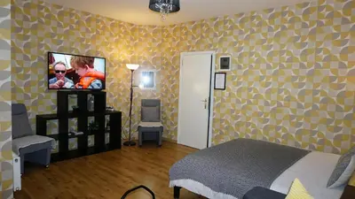 a bedroom with a bed and a tv on a wall at Sint-Jans Appartments in Antwerp