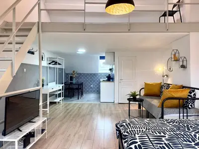 a loft apartment with a bed and a living room at Sint-Jans Appartments in Antwerp