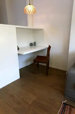a living room with a chair and a desk at Coeur Sablon in Brussels