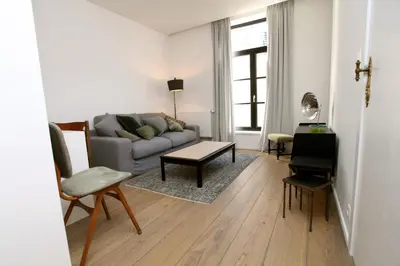 a living room with a couch and a table at Coeur Sablon in Brussels