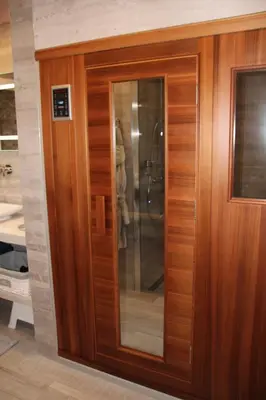 a wooden door with glass in a room at Vakantiewoning 't Rysselhof in Kaprijke