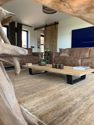 a living room with a couch and a table at Vakantiewoning 't Rysselhof in Kaprijke