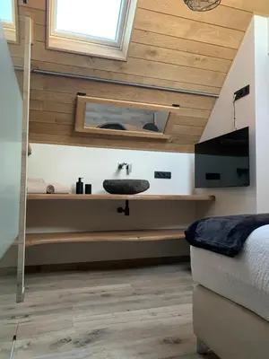 a bathroom with a sink in the middle of a room at Vakantiewoning 't Rysselhof in Kaprijke