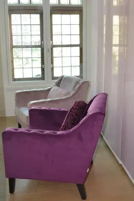 a purple couch in a room with windows at Antwerp old town appartment in Antwerp