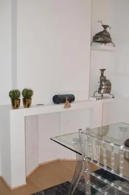 a dining room with a glass table and some plants at Antwerp old town appartment in Antwerp