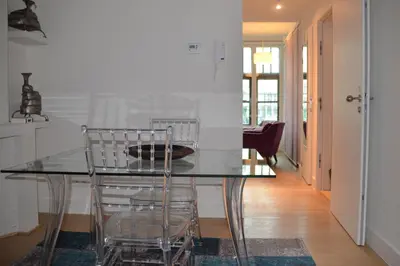 a dining room with a glass table and chairs at Antwerp old town appartment in Antwerp
