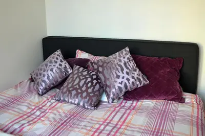 a pile of pillows sitting on top of a bed at Antwerp old town appartment in Antwerp