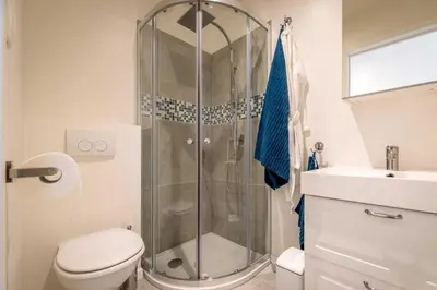a bathroom with a shower and a toilet and a sink at Studio Brussels Airport - Central in Zaventem
