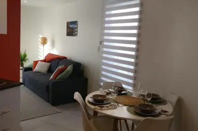 a living room with a table and a couch at Studio Brussels Airport - Central in Zaventem