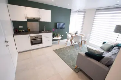 a kitchen and living room with a couch and a table at Studio Brussels Airport - EU-District in Zaventem
