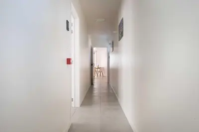 a hallway with white walls and a room with a table at Studio Brussels Airport - EU-District in Zaventem