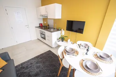 a dining room with a white table and chairs at Studio Brussels Airport - South in Zaventem