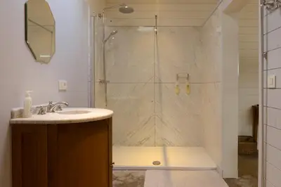 a bathroom with a shower with a sink at Logies De Hessie in Turnhout