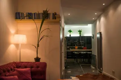 a living room with a red couch and a dining room at full 4 floors house at the center in Antwerp