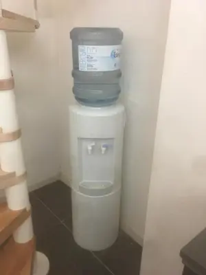 a stack of water bottles sitting on top of a toilet at full 4 floors house at the center in Antwerp