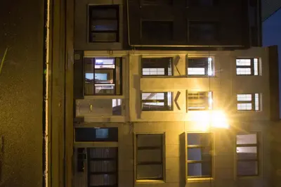 an apartment building with the sun shining through the windows at full 4 floors house at the center in Antwerp