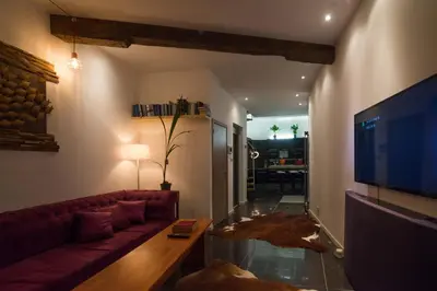a living room with a red couch and a tv at full 4 floors house at the center in Antwerp