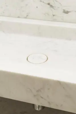 a white marble bath tub with a drain at Hotel Riga in Antwerp