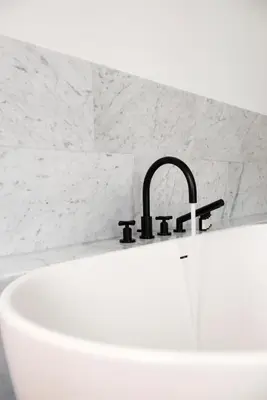 a bathroom with a sink and a faucet at Hotel Riga in Antwerp