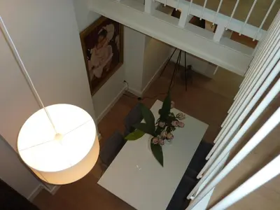 an overhead view of a living room with a table and a plant at Antwerp old town triplex apartment in Antwerp