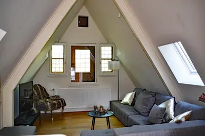 a living room with a couch and a table at Antwerp old town triplex apartment in Antwerp