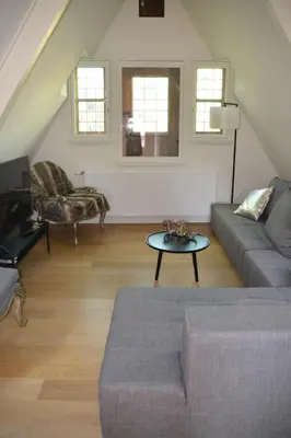a living room with a couch and a table at Antwerp old town triplex apartment in Antwerp